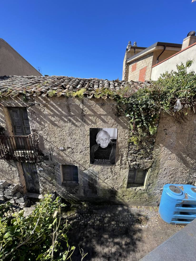 Portraits of elderly residents mounted on a village facade